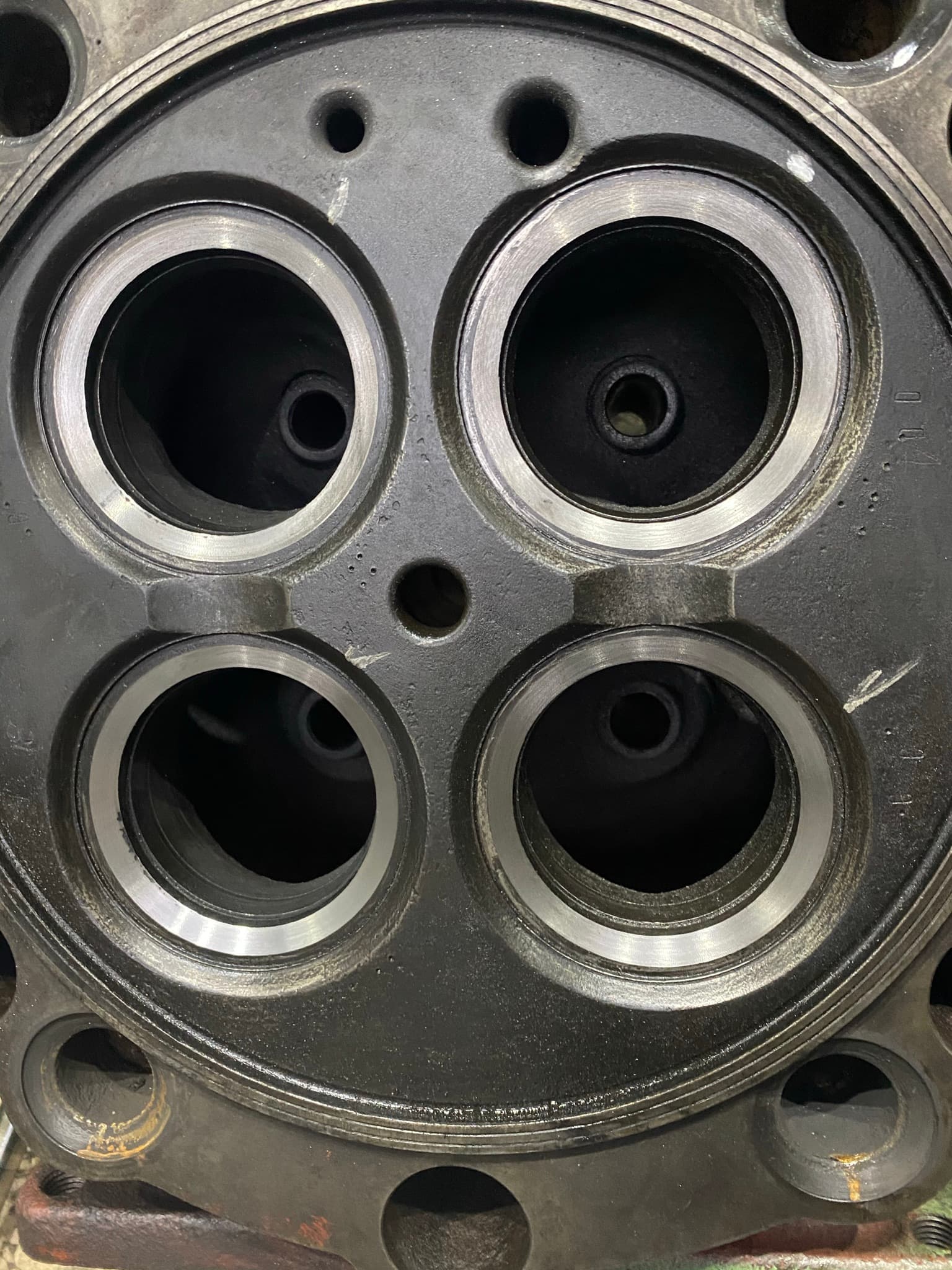 Cylinder head combustion face with restored valve seats